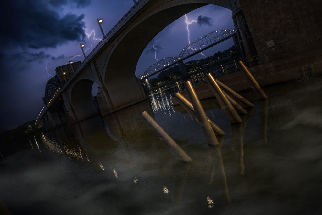 A bridge under a stormy sky